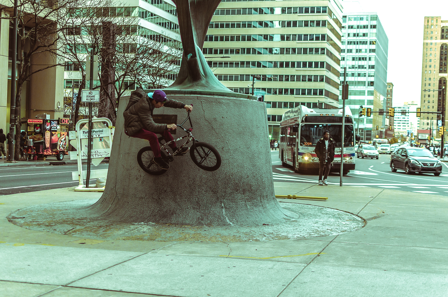 Scaling city monuments via bike outside City Hall