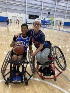 Xavier Ray and Caroline Cooke on a indoor basketball court.