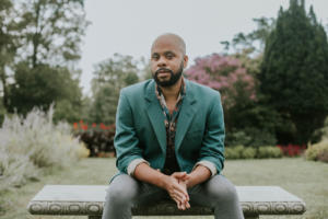 Portrait of R Eric Thomas on a bench