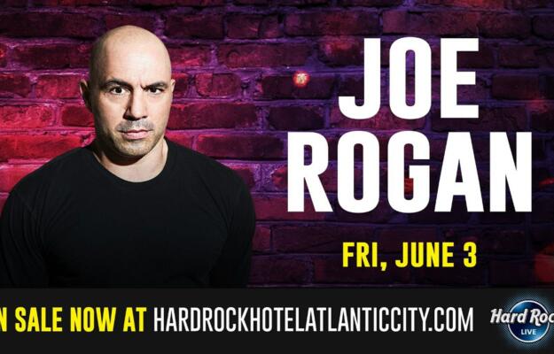 Joe Rogan standing in front of a brick wall. The picture includes graphic writing that reads, "Joe Rogan, Friday, June 3, on sale now at hardrockhotelatlanticcity.com"