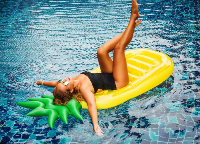 woman in an upside down pineapple pool float